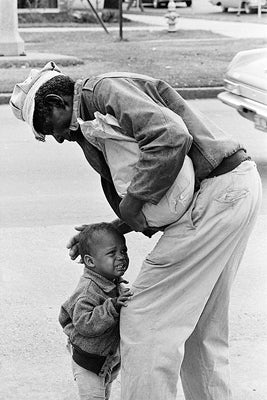 African American Man with Crying Child by McMahan Photo Archive